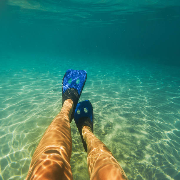 istock Girl diving under water 904327846