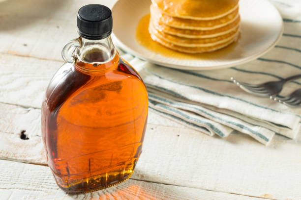 Raw Organic Amber Maple Syrup Raw Organic Amber Maple Syrup from Canada honey jar liquid gourmet stock pictures, royalty-free photos & images