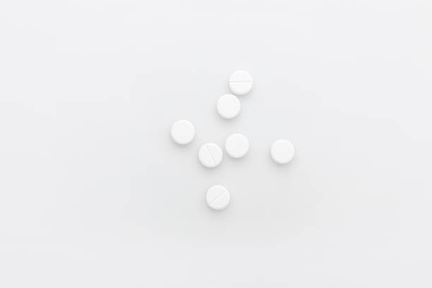scattered white pills isolated on white background
