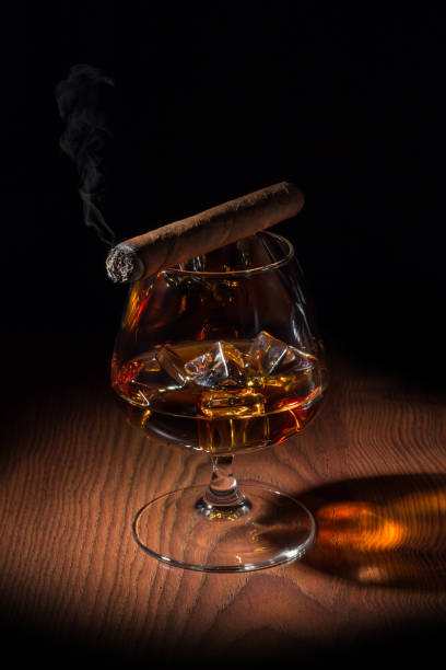 istock smoked cigar on a glass of cognac 904328514