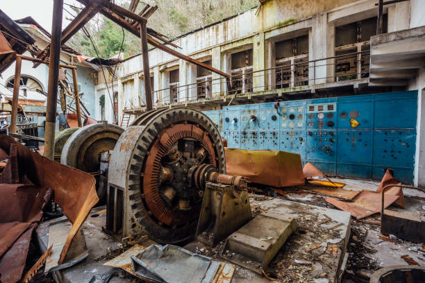 istock Ruined abandoned electrical substation. Rusty generator at machinery. Demolished roof 904335572