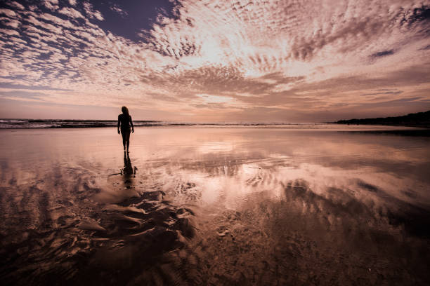 istock Woman silhouette on the beach. 904343346