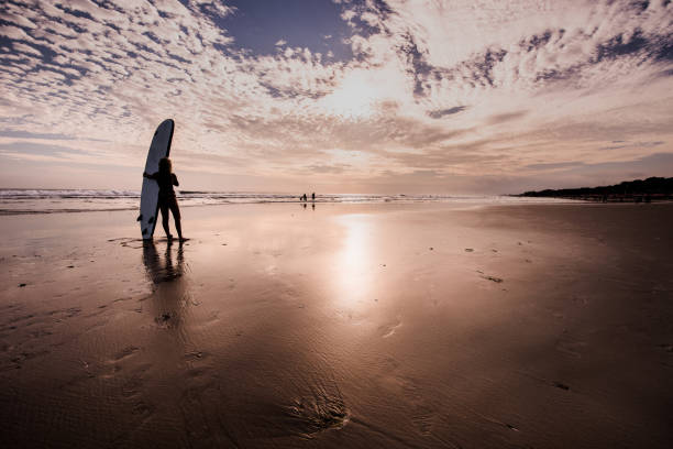 istock Caucasian woman with surfboard on the beach going to surf. 904343732