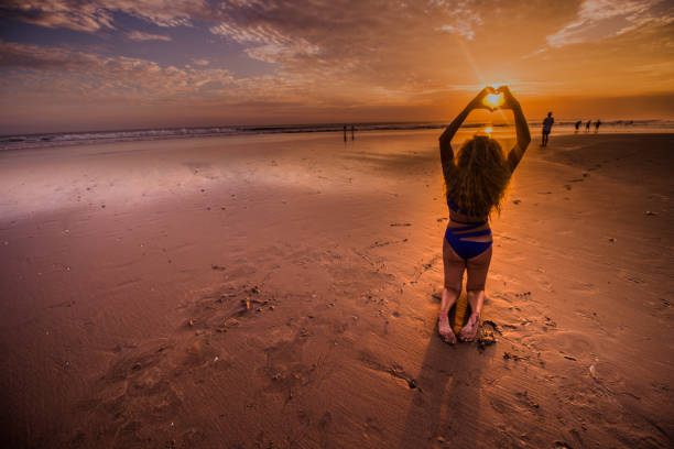 istock Young attractive female having fun on beach at sunset. 904344042