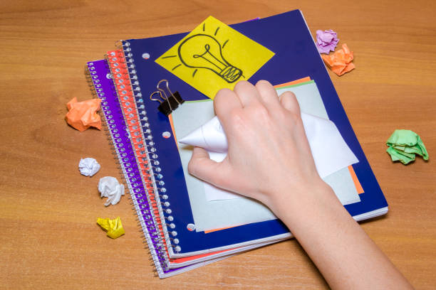 istock Idea concept with crumpled paper lightbulb and colored sheet with pen on wooden desktop 904344364