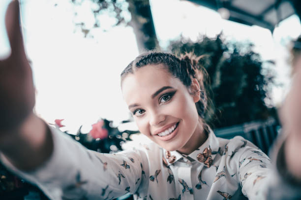 istock Smiling Beautiful Young Woman Making Selfie in a Cafe 904347848