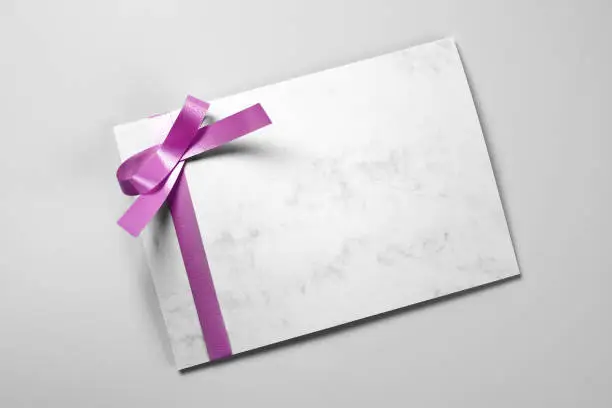 Blank greeting or thank you card decorated with violet ribbon