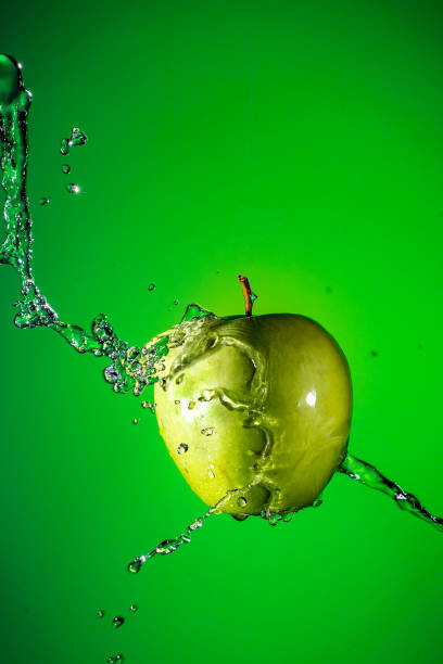 istock Green Apple on a green background 904352518