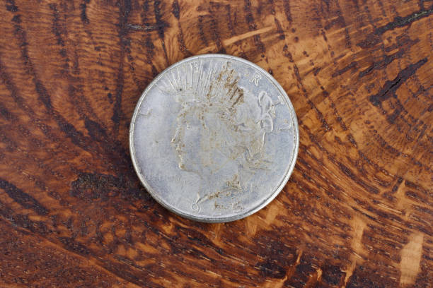 istock old vintage silver dollar on wooden background 904355082