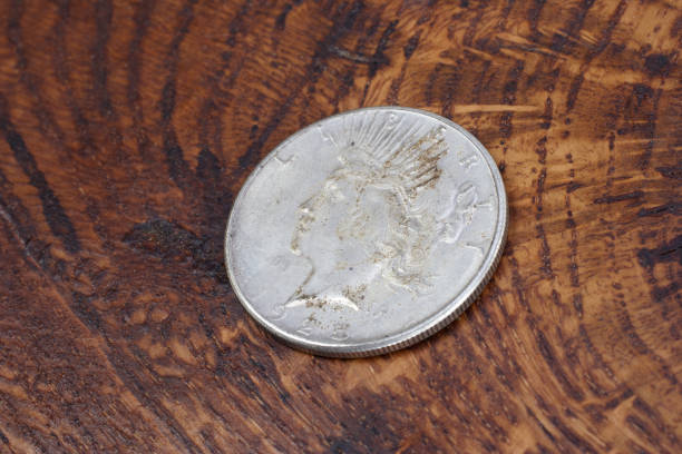 istock old vintage silver dollar on wooden background 904355186