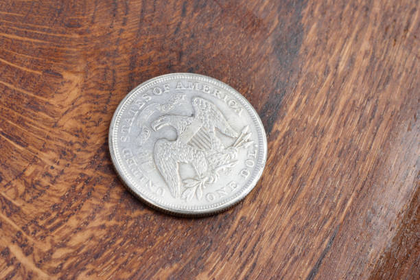 istock old vintage silver dollar on wooden background 904355302