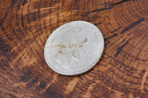 istock old vintage german coin on wooden background 904355872