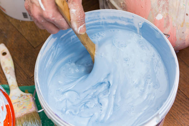 istock Mixing paint in a bucket 904371494