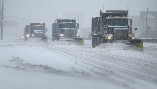 Snow Plows clearing a highway during a snow blizzard
