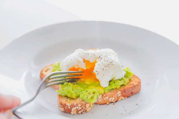 adult women eating healthy breakfast - poached egg imagens e fotografias de stock