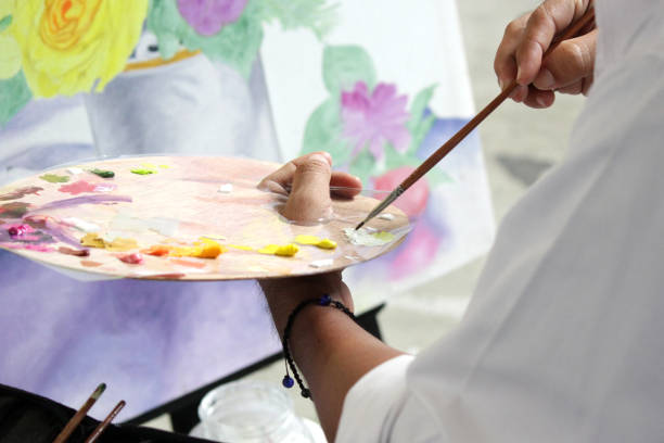 istock artist painting with water colors 904403586
