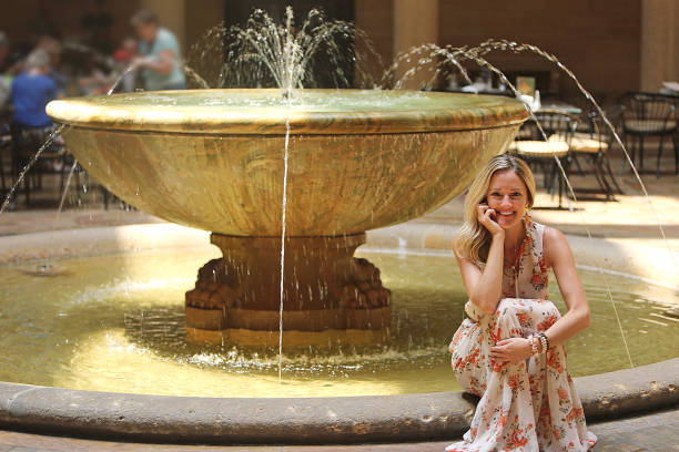 istock Beautiful Blonde by Water Fountain 904406726