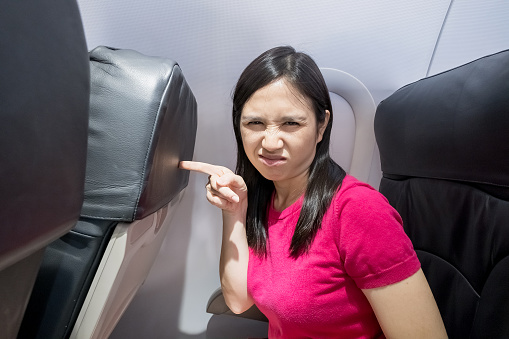 woman feel seat small in the airplane
