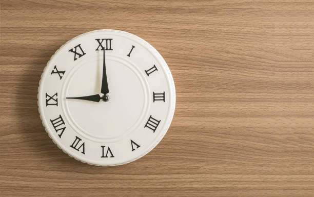 istock Closeup white clock for decorate in 9 o'clock on wood desk textured background with copy space 904407136