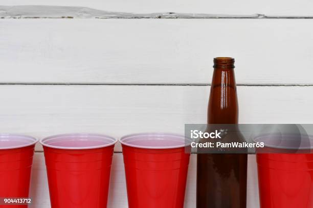 Red Solo Cups And Beer Bottles Stock Photo - Download Image Now - Cup, Individual Event, Red