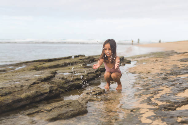 istock Young Girl Playing in Tide Pool on Hawaii Beach 904413952