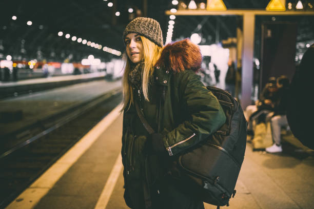 istock Young backpacker waiting for transportation at station in Germany 904421036