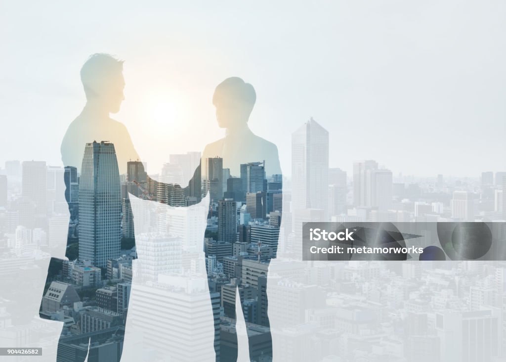 Marketing communication concept. Silhouette of business persons shaking hands. Handshake Stock Photo