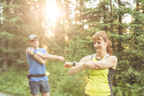 istock Older Couple Trail Running in Forest 904428132