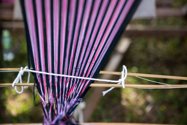 istock Colorful tread from Thai style wooden weaving loom 904434218