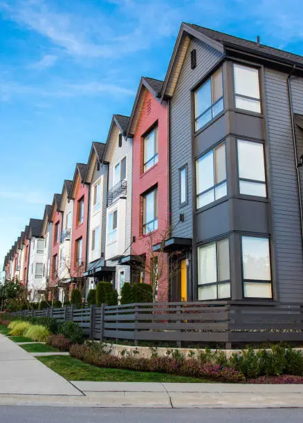 A row of new real estate townhouses or condominiums.