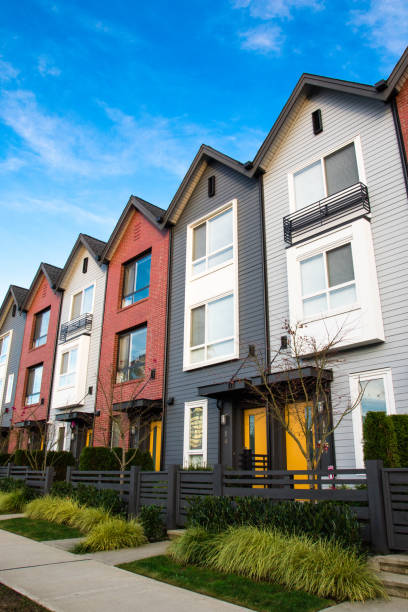 A row of new real estate townhouses or condominiums. A row of new real estate townhouses or condominiums. duplex stock pictures, royalty-free photos & images