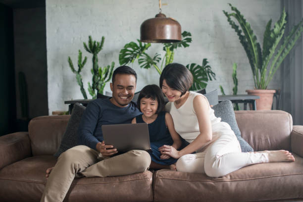 istock Asian family looking at the computer at home. 904442668