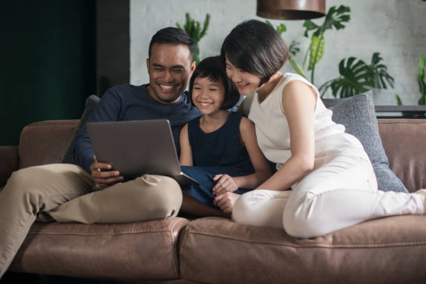 istock Asian family looking at the computer at home. 904442672