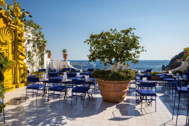 a beautiful terrace overlooking the coastal town of positano on amalfi coast.  italy - sky sea town looking at view imagens e fotografias de stock