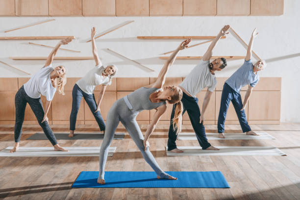 istock group of senior people stretching with instructor on mats in studio 904445894
