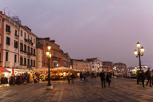 Venice, Italy - December 9, 2016: People at Venicein the evening with twilight sky.