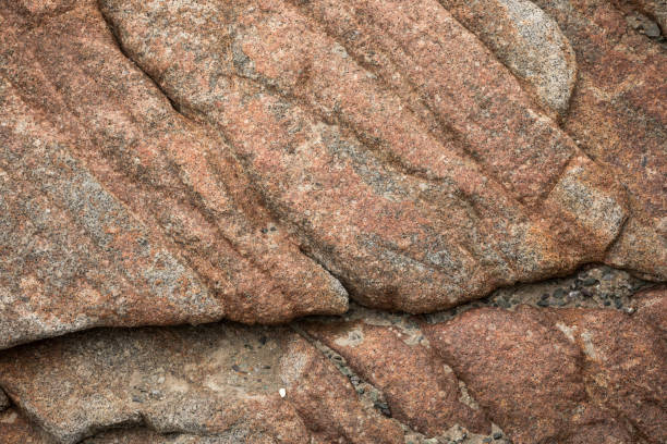 Stone texture at rocky beach; Telephoto lens close-up, no people;
