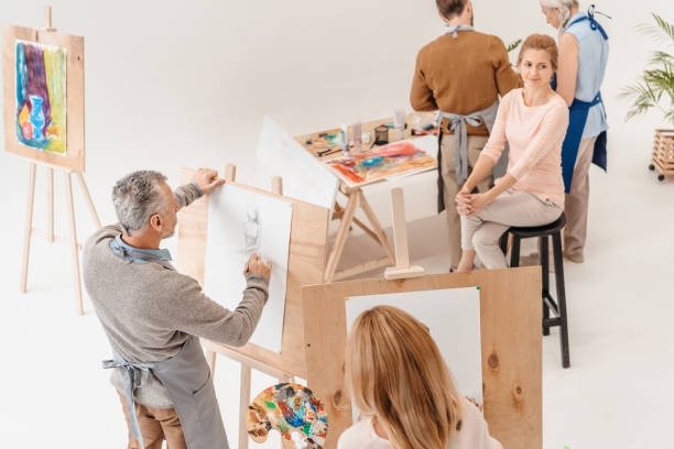 istock high angle view of senior students painting on easels at ast class 904449814