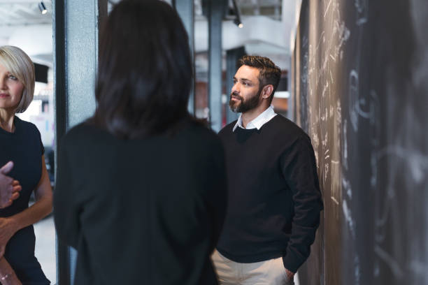 istock Business people planning by blackboard in office 904453424