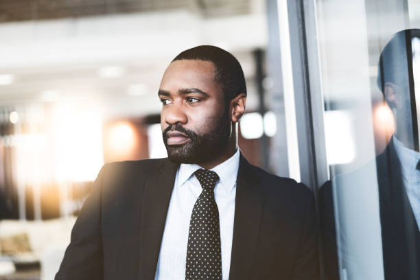 istock Thoughtful businessman leaning on glass 904455962