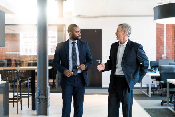 istock Businessmen giving high-five by desk in office 904457230