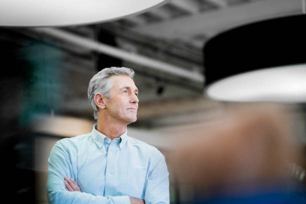 Thoughtful businessman looking away at office