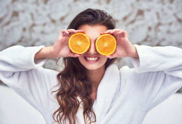 Oranges are here to brighten up the day! Shot of an attractive young woman holding up orange halves ascorbic acid stock pictures, royalty-free photos & images