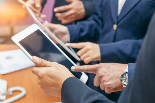 istock Cropped image group of business people using tablet computer in modern office 904463574