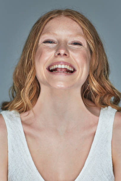 istock Happy young woman studio portrait 904464378