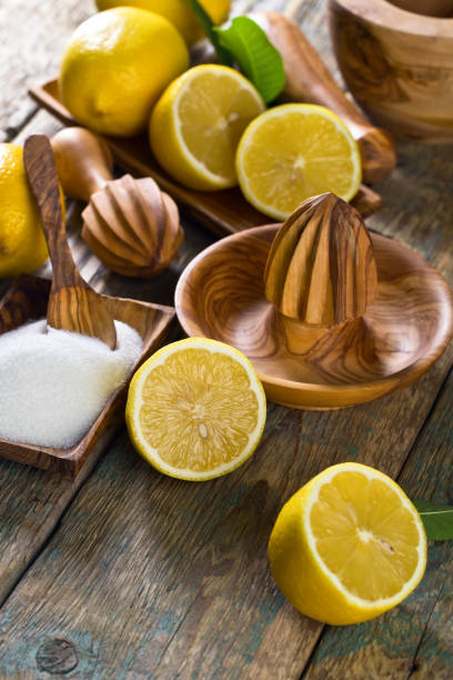 istock Lemons , sugar and old wooden squeezer . 904464526