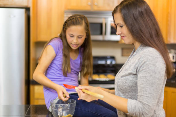 istock Mother and Daughter Bake Together in Modern Kitchen 904464864