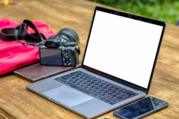 istock Mock up laptop and designer stuff on a wood table. 904465162
