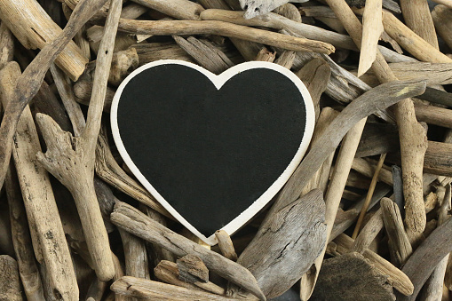 Driftwood Mockup. heart frame. frame from heart chalk board and dry sea driftwood . Blank empty . copy space
