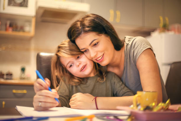 istock Mommy helping me to schoolwork. 904472878